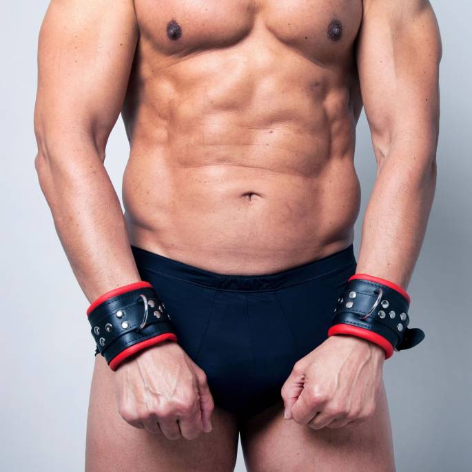 BLACK AND RED LEATHER HANDCUFFS